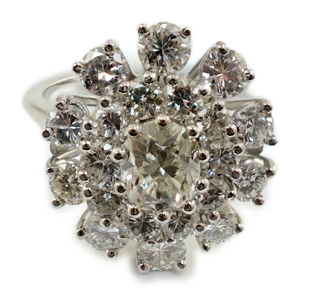 A platinum? and twenty one round cut diamond set oval cluster dress ring